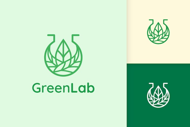 Logo da laboratorio verde a forma di foglia per scienza o chimica