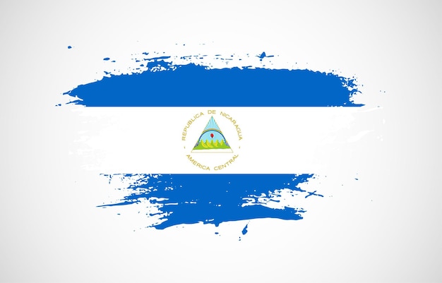 Grunge brush stroke with the national flag of nicaragua on a white isolated background