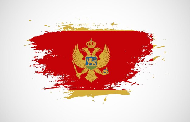 Vector grunge penseelstreek met de nationale vlag van montenegro op een witte geïsoleerde achtergrond