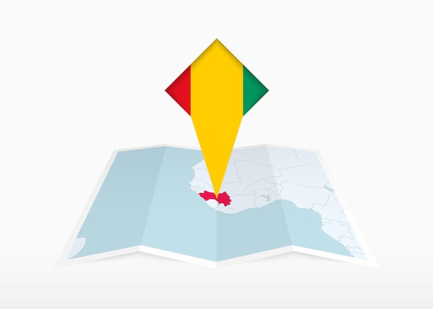Гвинея изображена на сложенной бумажной карте и приколота маркером местоположения с флагом Гвинеи.