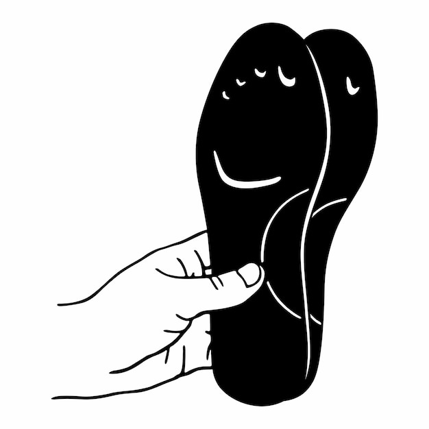 Hand holds a pair of orthopedic insoles