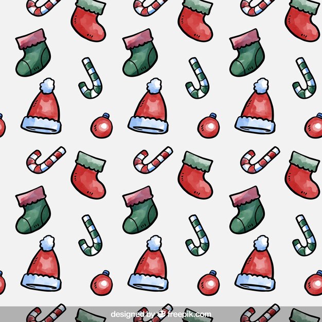 靴下やキャンディー杖を持つ手塗りのクリスマスのパターン