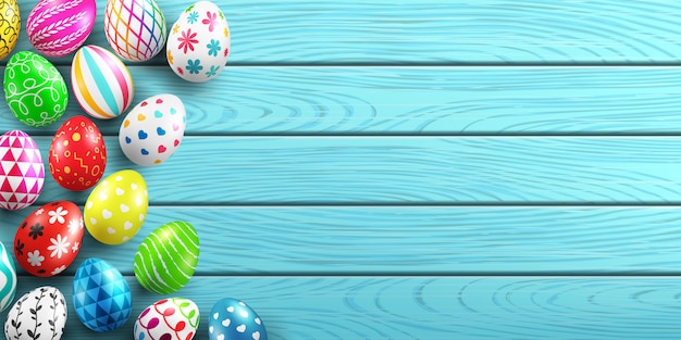 Handmade painted easter eggs on wood background.