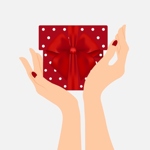 Hands holding a gift with red bow