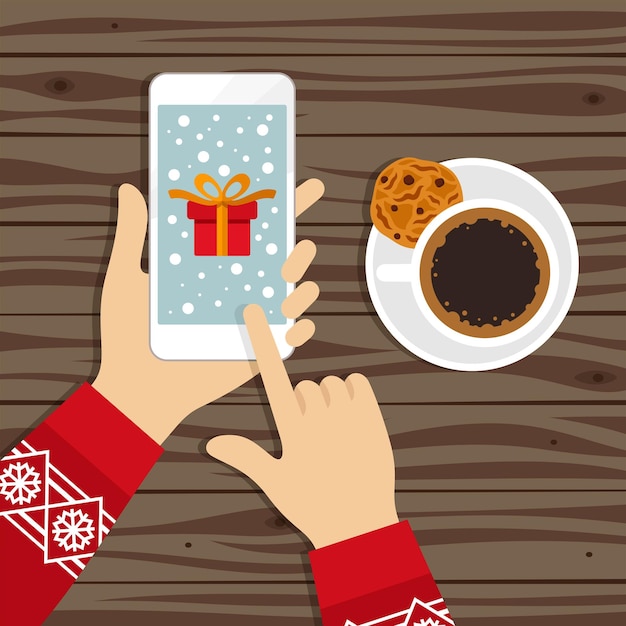 Hands holding phone with christmas gift on screen