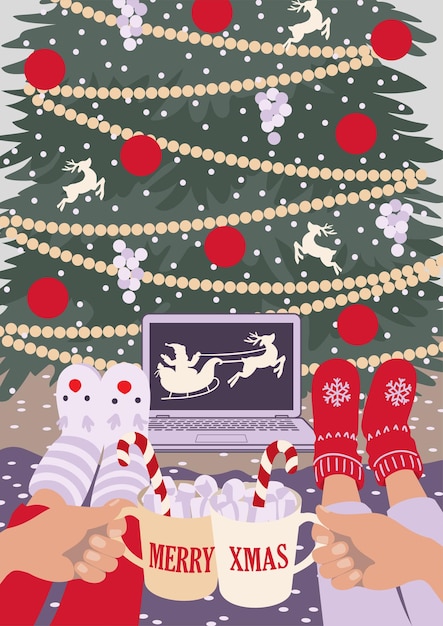 Hands with cups laptop with Santa Claus and Christmas tree