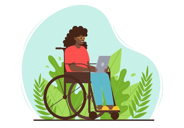 Happy adult woman is sitting with a laptop in a wheelchair A lady with disabilities uses a computer