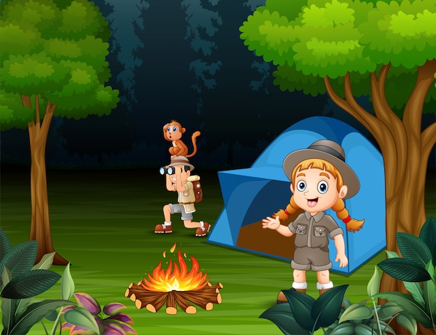 Happy children camping out in a forest