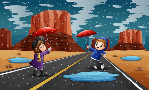 Happy children holding umbrella in raining