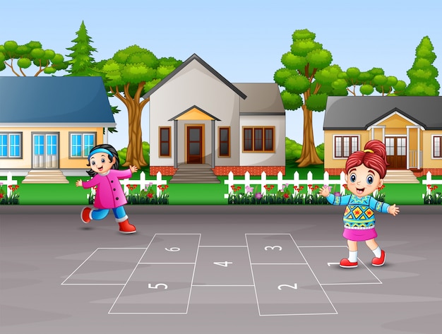 Happy children playing hopscotch in the yard