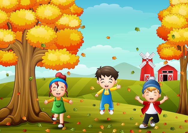 Happy children playing with autumn leaves