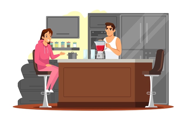 Happy couple at kitchen together young man cooking smoothie or juice in blender woman sitting at table and waiting Love and romance at house with modern interior design