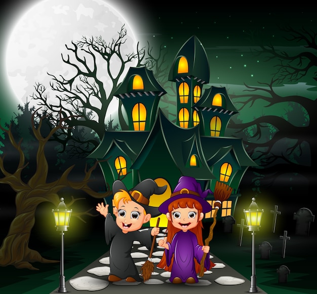 Happy couple witch in front of the haunted house