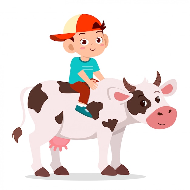 Happy cute kid boy riding cow