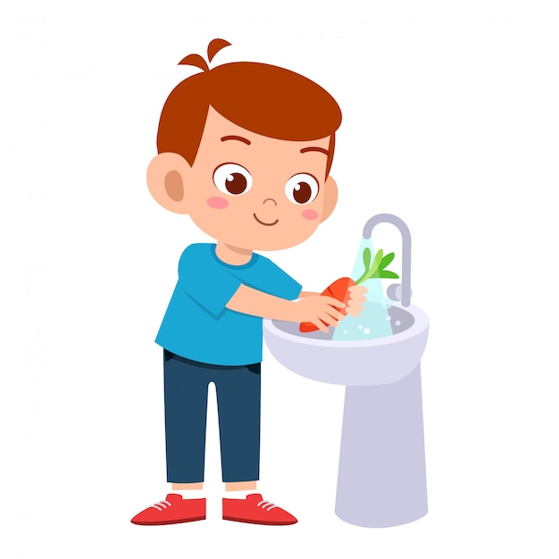 Happy cute kid boy wash vegetable fruit clean