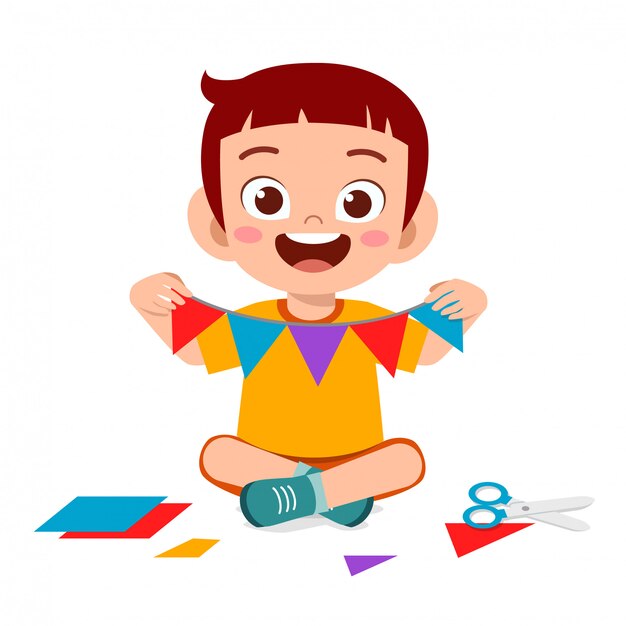 Happy cute little kid boy make paper craft