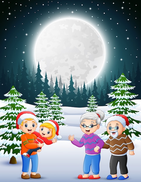Happy familly in the snowy garden at night