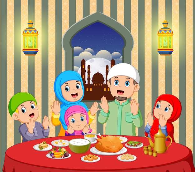 A happy family are praying before eating in their house with beautiful view from the window