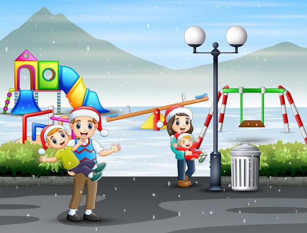 Famiglia felice divertirsi al parco giochi innevato