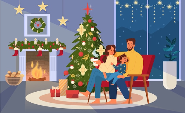 Happy family sitting next to Christmas tree, holding cup of cocoa.
