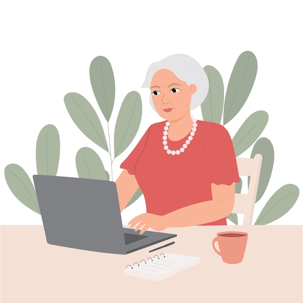 Happy granny with laptop on background of green plants Business elderly woman is working communicating watching video