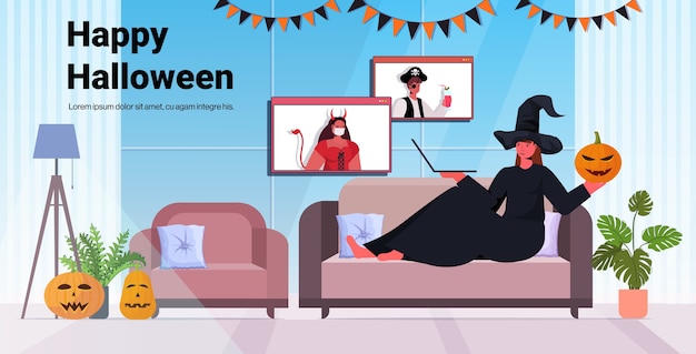 happy halloween holiday celebration woman in witch costume discussing with friends during video call living room interior 