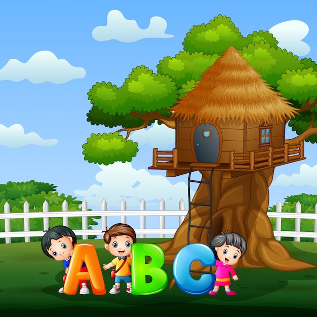 Happy kids holding abc text in the park