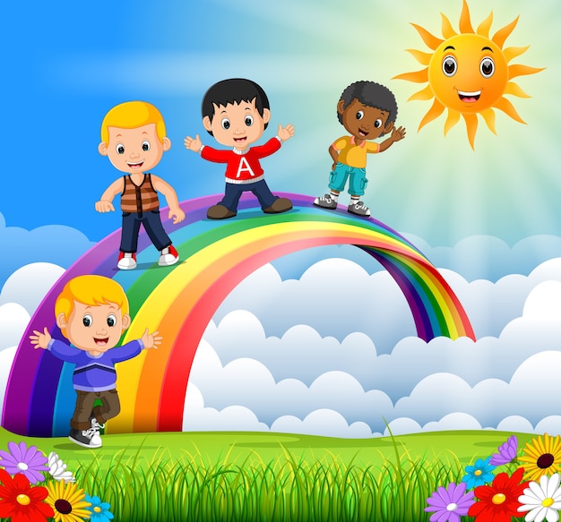 Happy kids standing over the rainbow