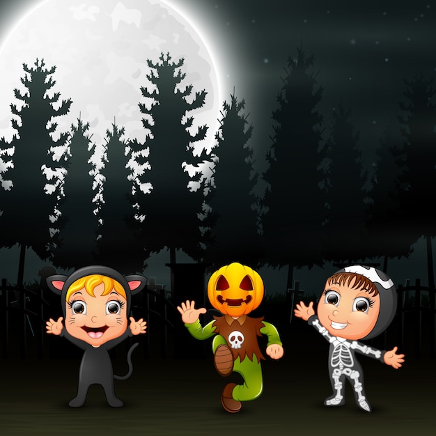 Vector happy kids wearing halloween costume in the garden at night