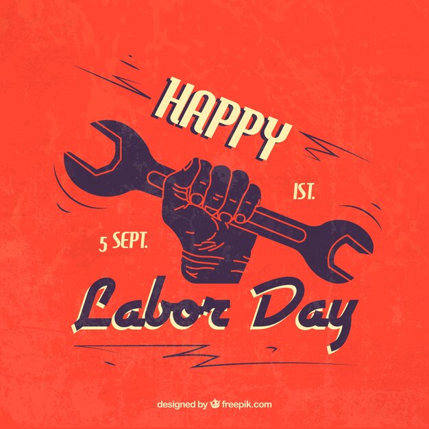 Happy labor day with hand holding a wrench