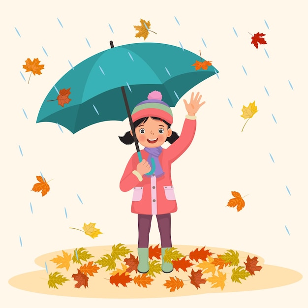 happy little girl holding umbrella under rain with fallen leaves in autumn