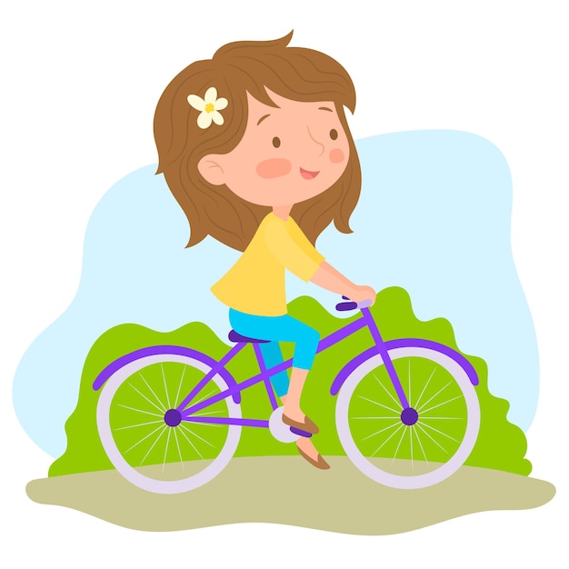 Happy little girl riding a bike at the park