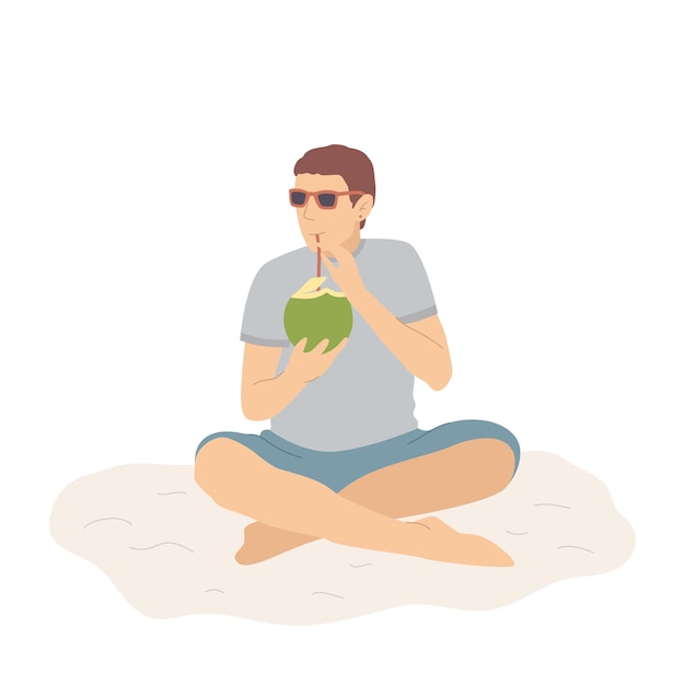 Счастливый человек в шортах на песчаном пляже пьет кокосовый коктейль и расслабляется