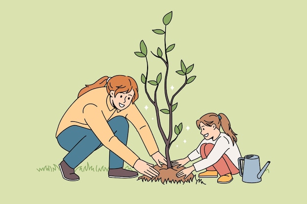 Happy mom and daughter plant tree together