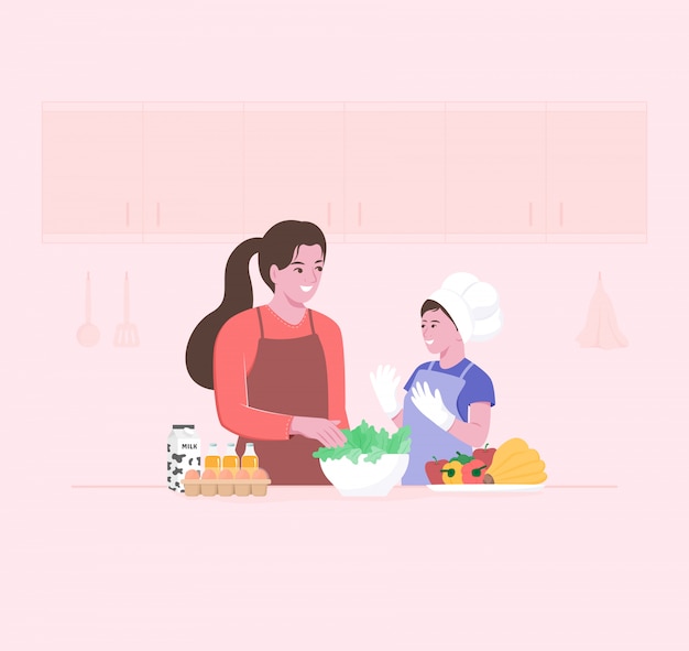 Счастливая мама и маленький ребенок готовит салаты из свежих овощей на кухне. Малыш участвует в кулинарии.