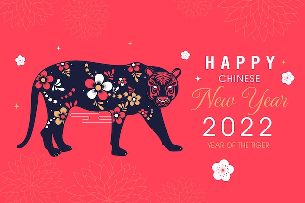 Happy new year 2022 of the tiger written in Chinese character paper art style with elegant flowers