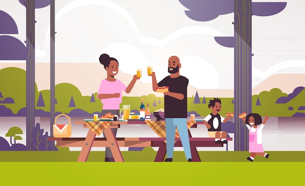 Vector happy parents and children eating hot dogs drinking juice african american family having picnic weekend concept river bank landscape background flat full length horizontal