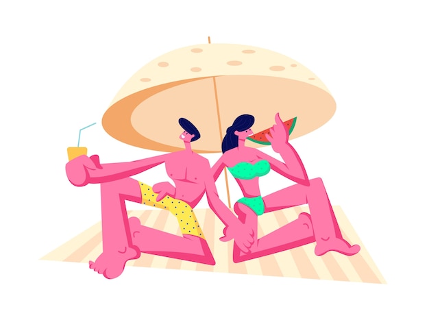 Happy young couple relaxing on beach under sun umbrella drinking juice, eating watermelon