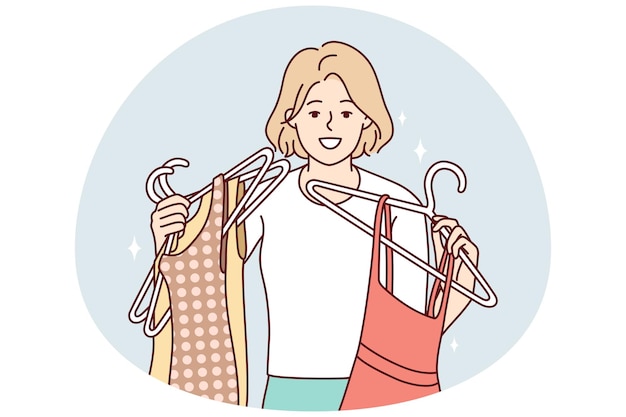 Happy young woman with dresses on hangers shopping in mall Smiling girl buying fashion