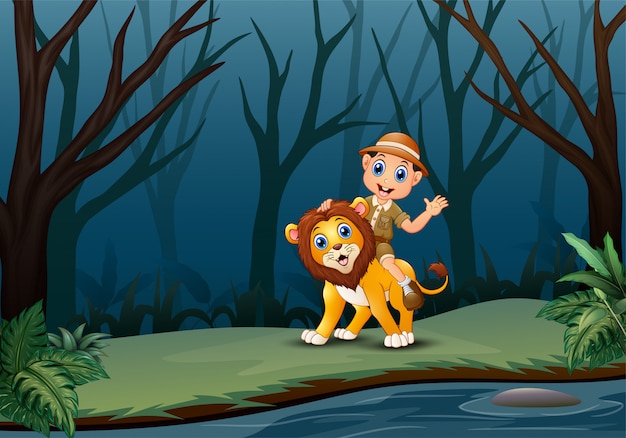 Happy zookeeper boy and lion in a forest