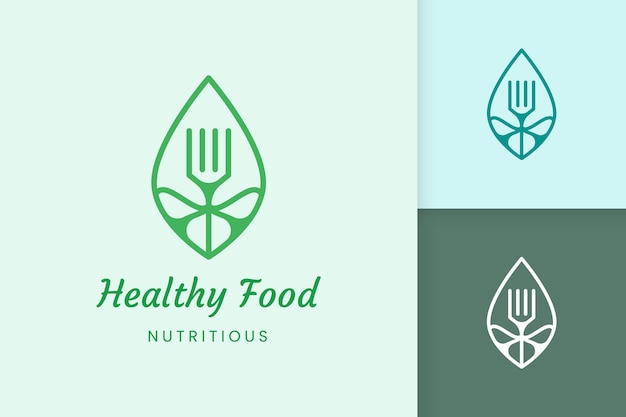 Logo di cibo sano a forma di forchetta e foglia