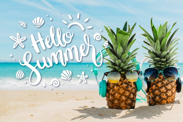 Hello summer lettering with pineapples on beach