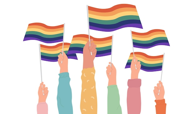 Human hands holding rainbow transgender and lgbt flags during pride monthor daycelebration orparade