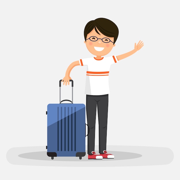 Isolated happy boy with blue suitcase on a white background