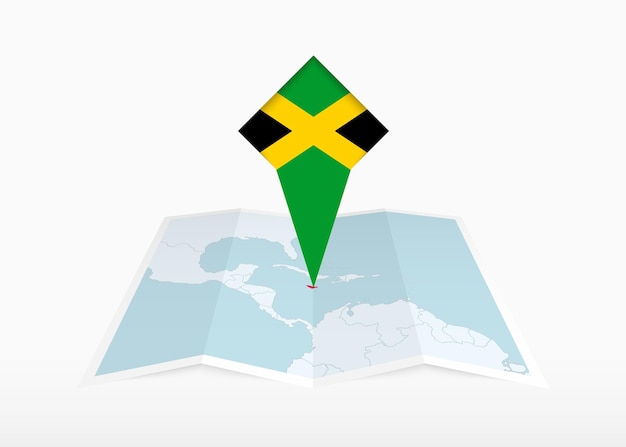 ジャマイカは折り畳まれた紙の地図に描かれており、ジャマイカの国旗が付いた位置マーカーがピンで留められています