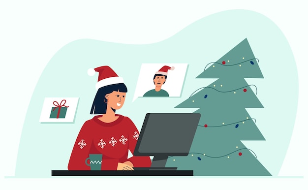 Kerst online Een jonge mooie vrouw communiceert met een vriend via een videoconferentie