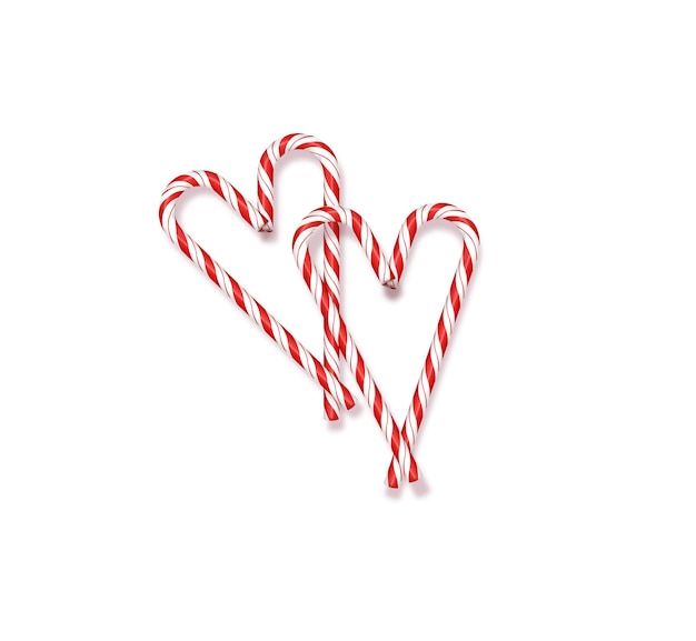 Kerst rode en witte lolly's op een witte achtergrond bekleed in de vorm van kerstharten en v...