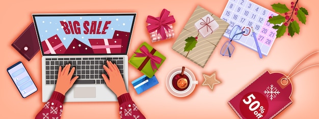 Kerst winter online winkelen achtergrond met bovenaanzicht van de werkplek, cadeautjes, laptop, handen, kalender