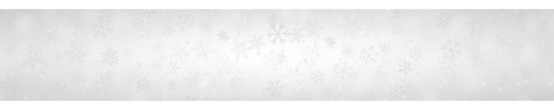 Kerstbanner van sneeuwvlokken in verschillende vormen, maten en transparantie op grijze achtergrond