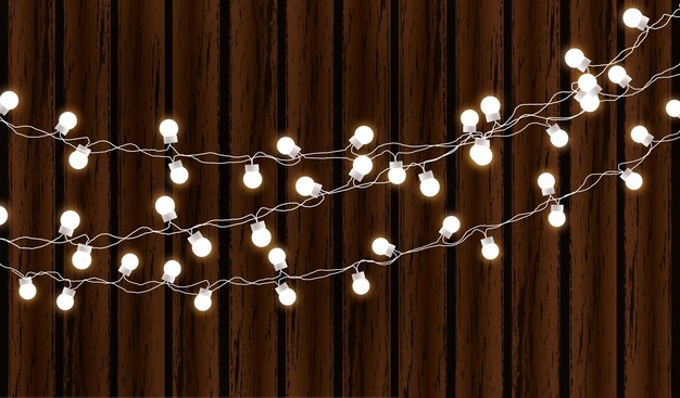 Vector kerstverlichting geïsoleerd op donkere houten achtergrond gloedslinger vector gloed xmas gloeilampen op draden